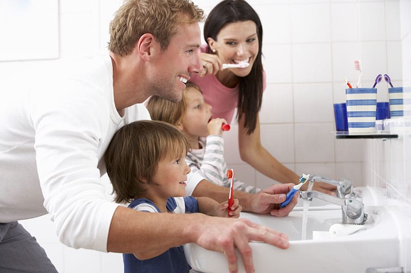 A Family Brushing their Teeth Together — Dentist in Palm Beach, QLD