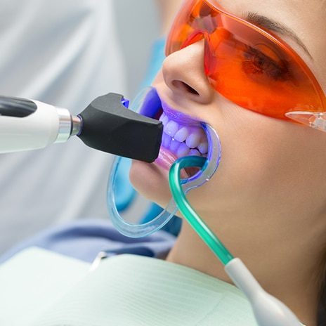 A dentist using a Tooth Filling Ultraviolet Lamp