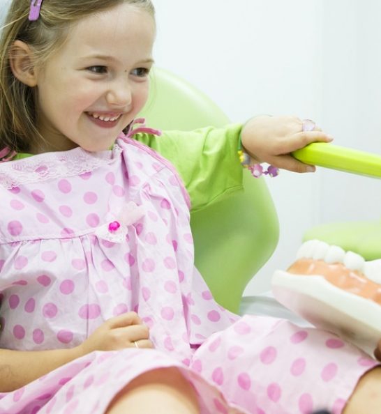 Young girl practising brushing teeth — Dentist in Palm Beach, QLD