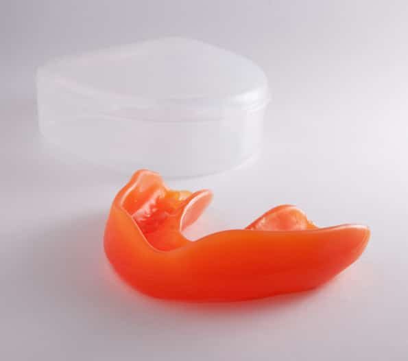 Orange Mouthguard With Transparent Case — Dentist in Palm Beach, QLD