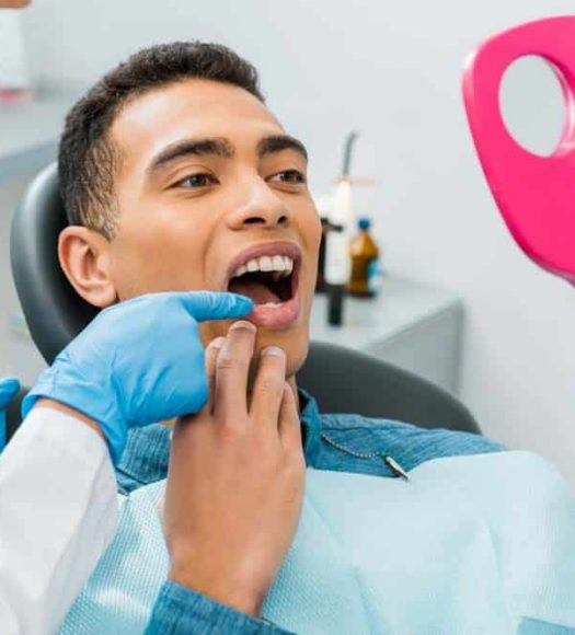 Dentist Pointing On Patients Tooth