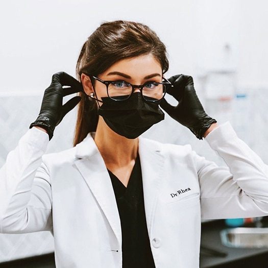 Dentist with Eyeglasses Wearing Black Face Mask — Dentist in Palm Beach, QLD